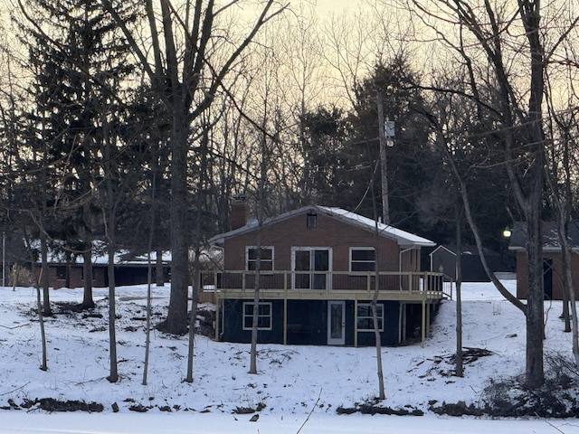 snow covered property featuring a deck