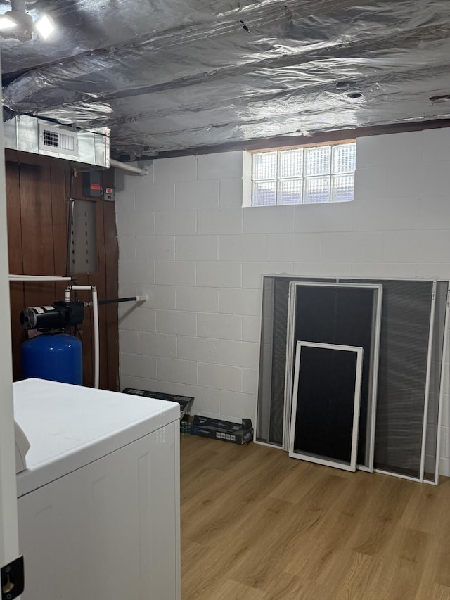 laundry room with washer / dryer and light hardwood / wood-style flooring