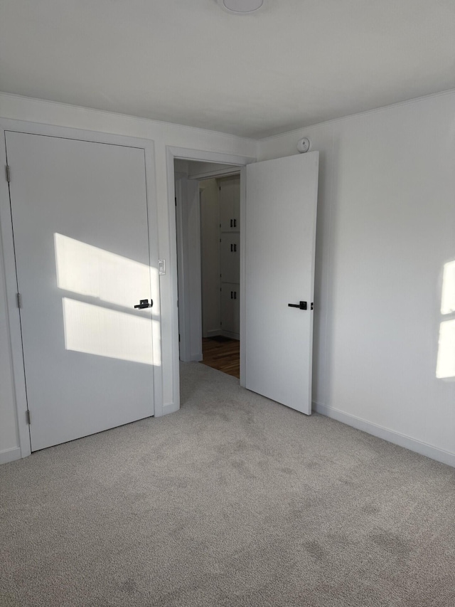 unfurnished room with light carpet