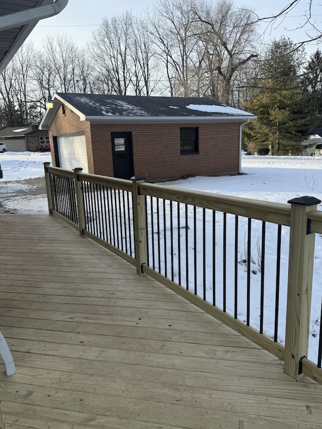 snow covered deck featuring a garage