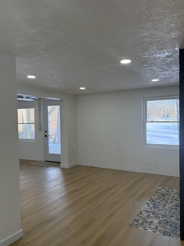 empty room with hardwood / wood-style flooring and a textured ceiling