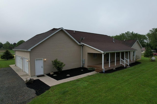 4344 N US Highway 68, West Liberty, OH 43357 - view of home's exterior featuring a lawn, a porch, roof with shingles, and a garage