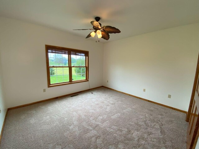 4344 N US Highway 68, West Liberty, OH 43357 - unfurnished room with carpet flooring, visible vents, baseboards, and a ceiling fan