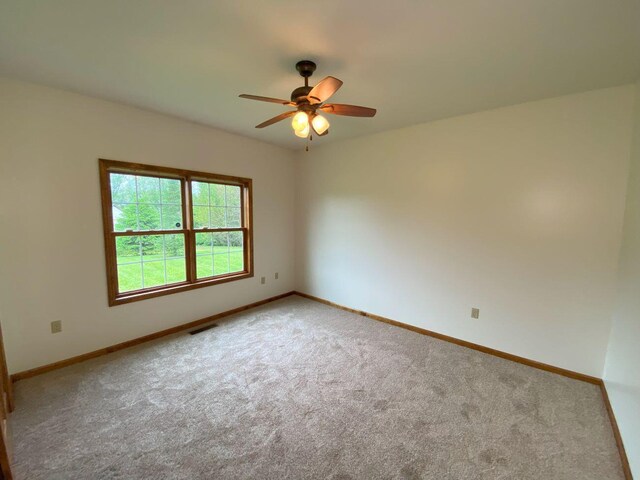 4344 N US Highway 68, West Liberty, OH 43357 - carpeted empty room with baseboards, a ceiling fan, and visible vents