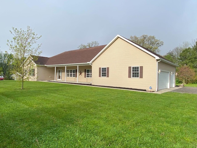 4344 N US Highway 68, West Liberty, OH 43357 - rear view of house with a yard, driveway, a porch, and a garage