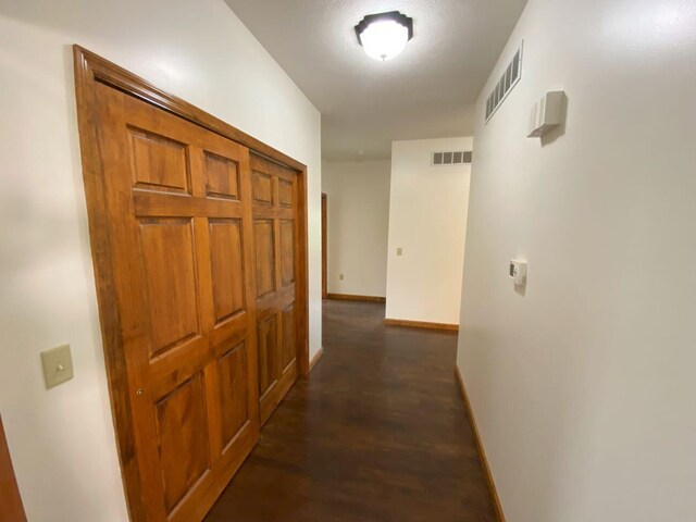 4344 N US Highway 68, West Liberty, OH 43357 - hallway with baseboards, visible vents, and dark wood-type flooring