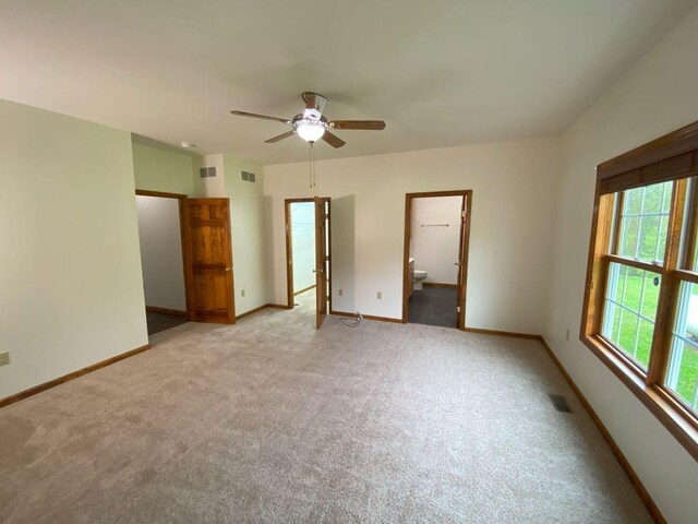 4344 N US Highway 68, West Liberty, OH 43357 - unfurnished bedroom with ensuite bathroom, light carpet, baseboards, and visible vents