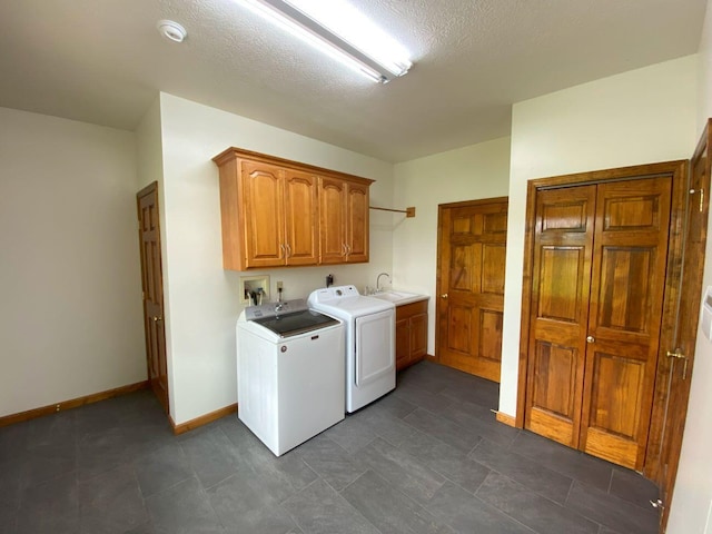 4344 N US Highway 68, West Liberty, OH 43357 - clothes washing area with a sink, cabinet space, a textured ceiling, washer and dryer, and baseboards