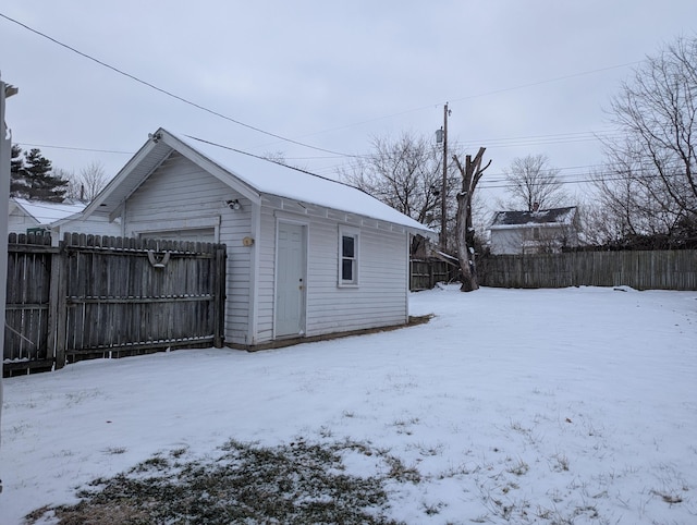 snow covered structure with fence