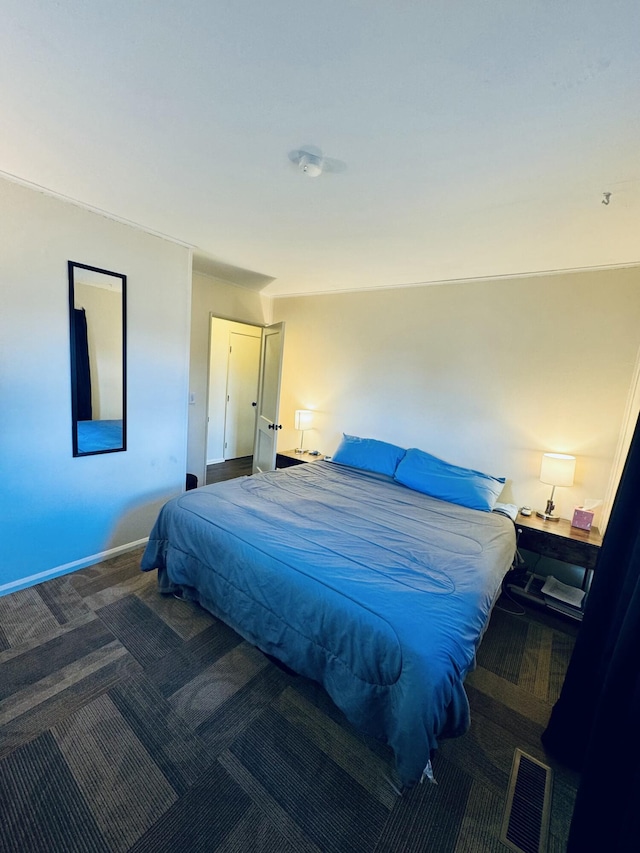 carpeted bedroom with visible vents and baseboards