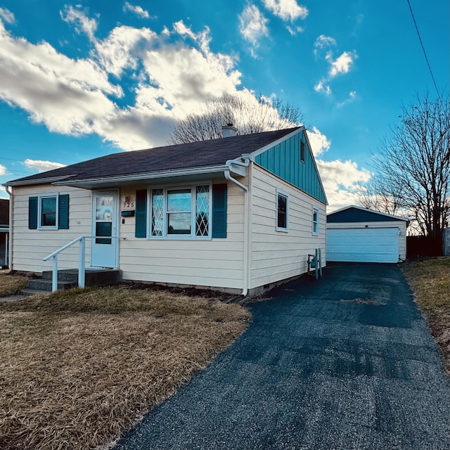 view of front facade featuring an outbuilding, board and batten siding, and a detached garage