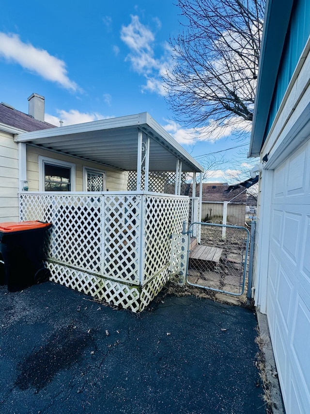 view of property exterior featuring a garage and fence