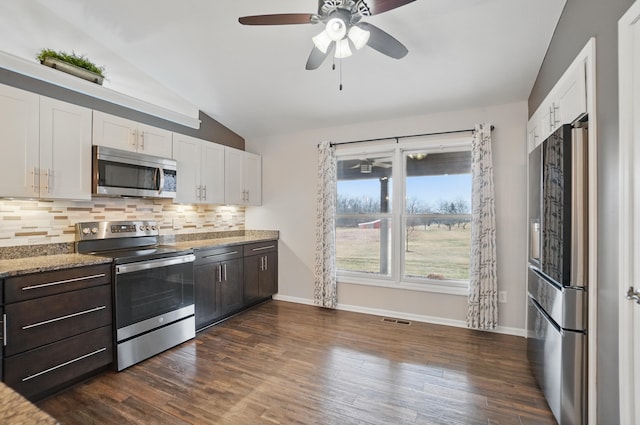 kitchen featuring visible vents, stainless steel appliances, white cabinetry, and dark brown cabinetry