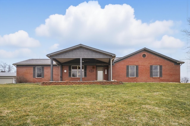 view of front of house featuring brick siding and a front lawn