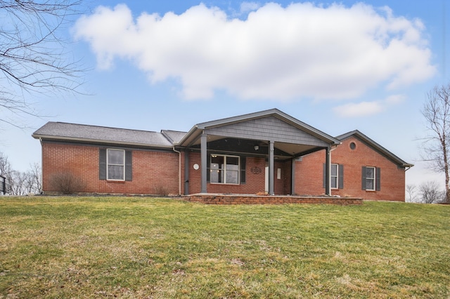 single story home with brick siding and a front lawn