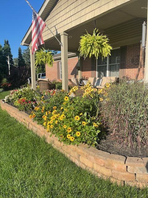 view of side of property featuring a yard and brick siding