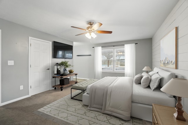 bedroom featuring baseboards, a ceiling fan, and light colored carpet