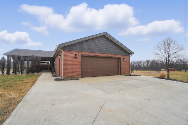 view of side of property featuring brick siding and an attached garage