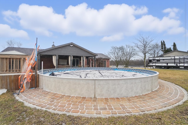 view of swimming pool with a lawn