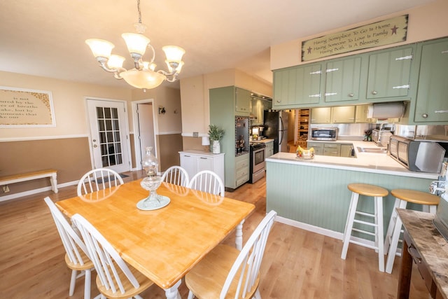 17689 Fort Loramie Swanders Rd, Sidney, OH 45365 - dining space featuring a chandelier and light wood-type flooring