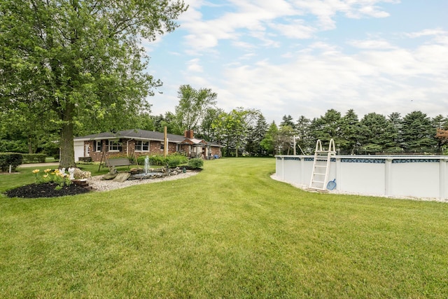 17689 Fort Loramie Swanders Rd, Sidney, OH 45365 - view of green lawn featuring an outdoor pool and view of wooded area