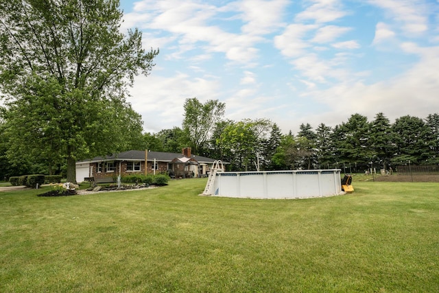 17689 Fort Loramie Swanders Rd, Sidney, OH 45365 - view of grassy yard with view of wooded area and an outdoor pool