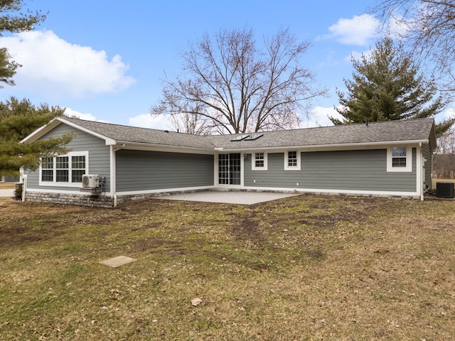 back of property with a lawn and a patio area