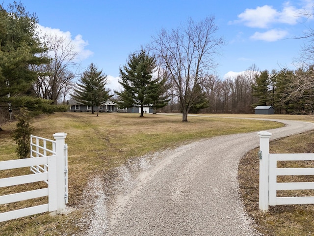 view of street with gravel driveway