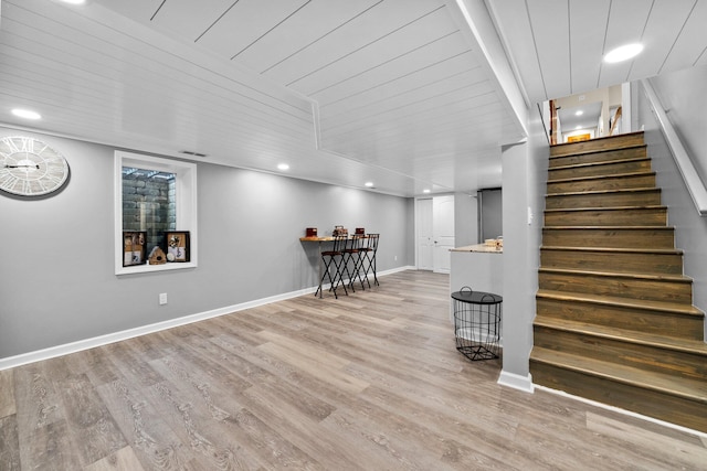 interior space with baseboards, light wood-style flooring, and stairs