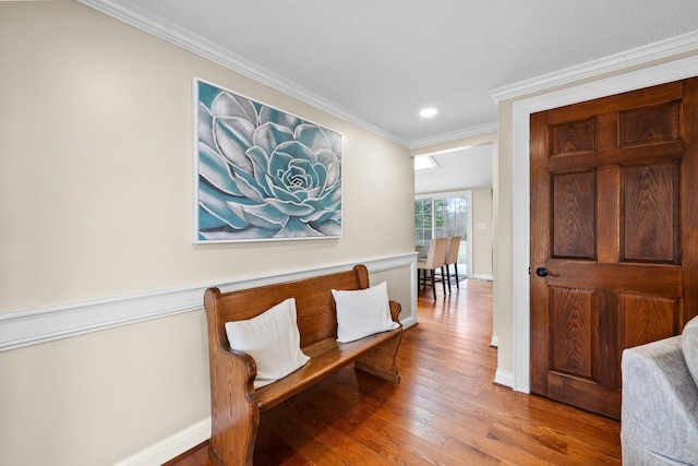 sitting room featuring recessed lighting, baseboards, hardwood / wood-style floors, and ornamental molding