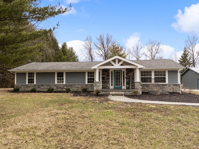 view of front of home with stone siding, a porch, a shingled roof, and a front lawn