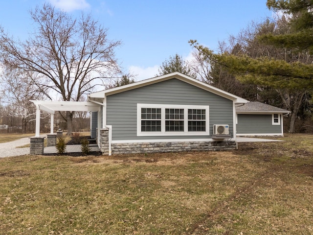 exterior space with a carport, stone siding, driveway, and a front yard