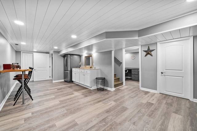 interior space with stairs, wooden ceiling, light wood-type flooring, and freestanding refrigerator