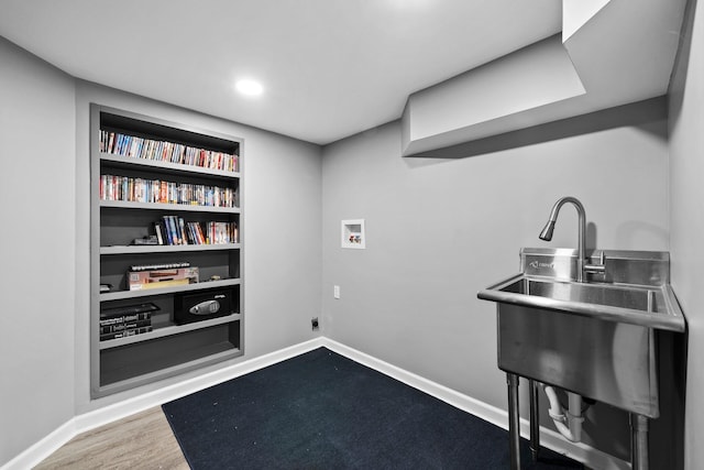 interior space featuring built in shelves, baseboards, dark wood finished floors, laundry area, and hookup for a washing machine