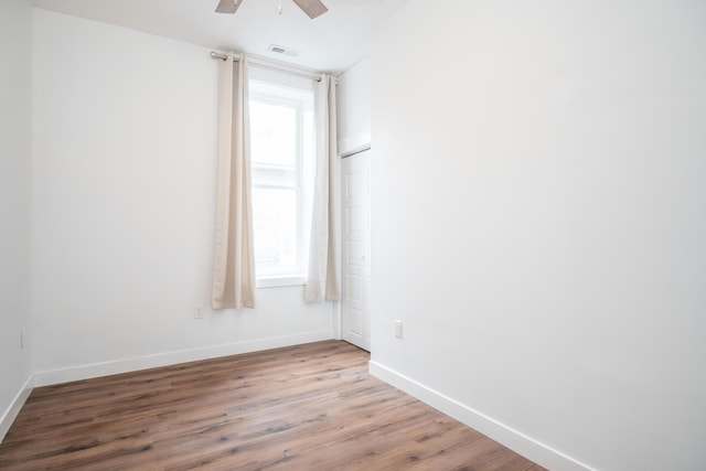 spare room featuring hardwood / wood-style flooring and ceiling fan