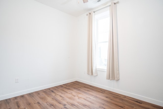 empty room featuring hardwood / wood-style flooring and ceiling fan