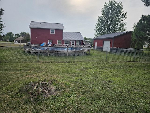 6822 Watercraft Dr, Huntsville, OH 43324 - fenced backyard featuring a garage, an outbuilding, and a deck