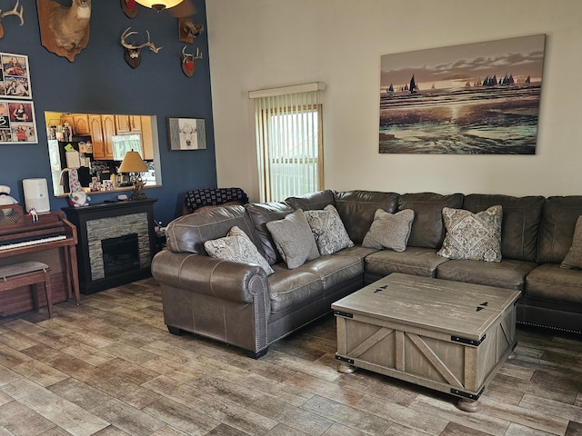6822 Watercraft Dr, Huntsville, OH 43324 - living room featuring light wood-style flooring, a fireplace, and a towering ceiling