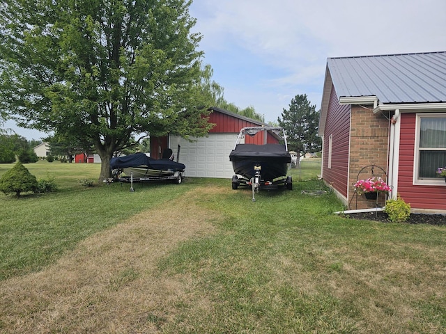 6822 Watercraft Dr, Huntsville, OH 43324 - view of grassy yard with a detached garage and an outdoor structure