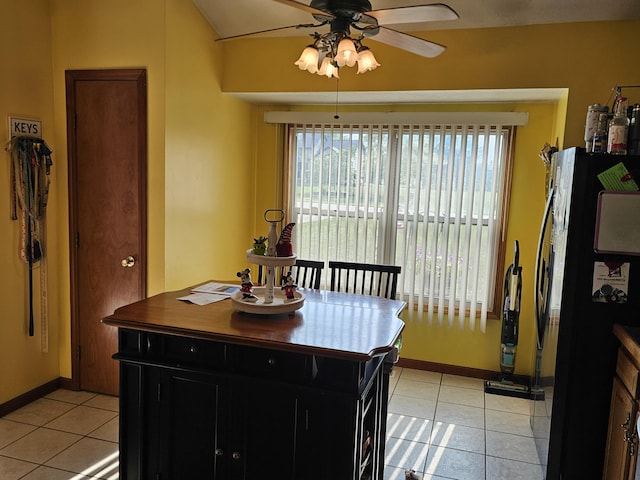 6822 Watercraft Dr, Huntsville, OH 43324 - kitchen with freestanding refrigerator, ceiling fan, light tile patterned floors, and dark cabinets