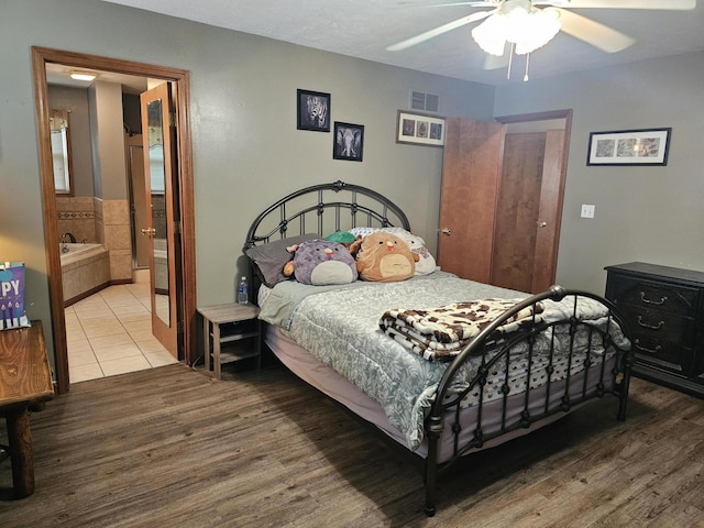 6822 Watercraft Dr, Huntsville, OH 43324 - bedroom with wood finished floors, ceiling fan, and ensuite bathroom