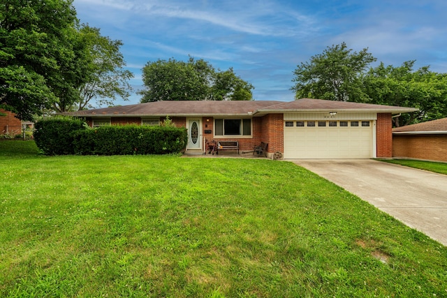 2631 Camino Pl, Kettering, OH 45420 - single story home with driveway, a garage, a front lawn, and brick siding