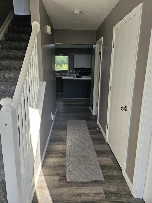 2973 Kicking Bird Trce, Dublin, OH 43017 - hallway with dark wood-style floors and stairway