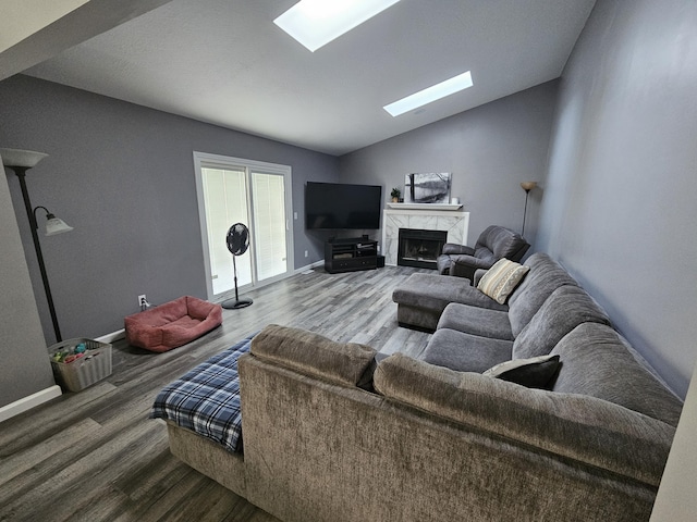 2973 Kicking Bird Trce, Dublin, OH 43017 - living room with wood finished floors, a skylight, a high end fireplace, and vaulted ceiling