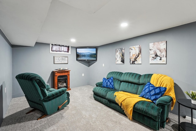 carpeted living area with recessed lighting and a glass covered fireplace