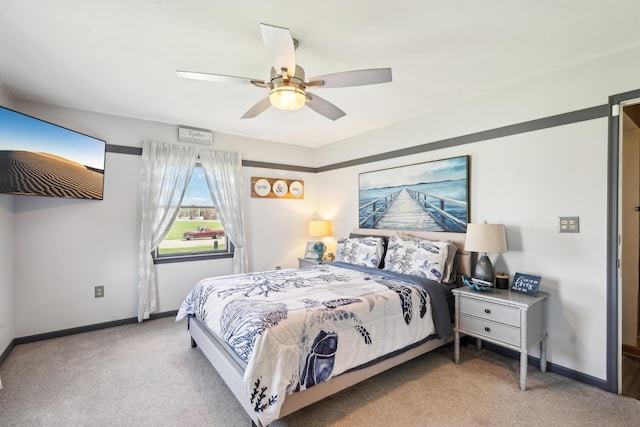 carpeted bedroom with baseboards and ceiling fan