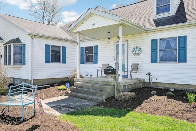 view of front of home featuring roof with shingles and a patio