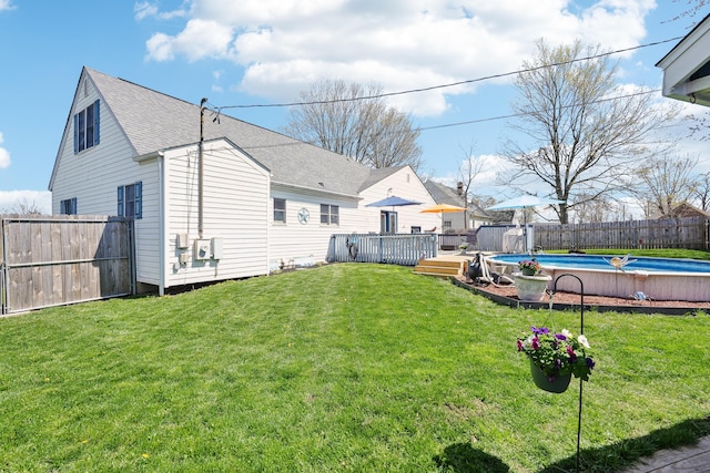 view of yard featuring a fenced backyard, a deck, and a fenced in pool