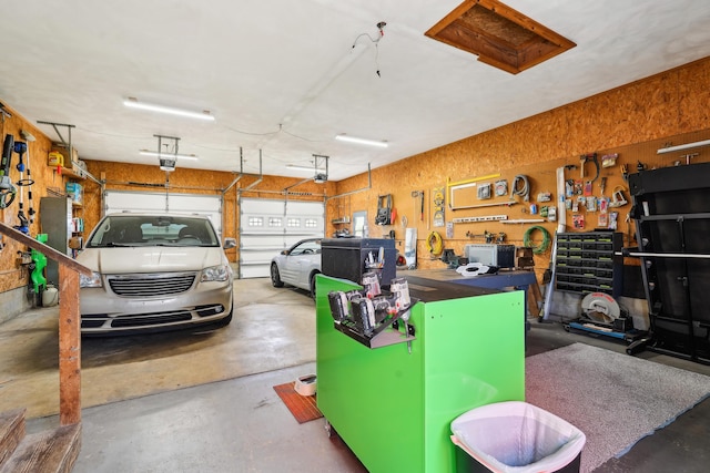 garage with a workshop area and a garage door opener