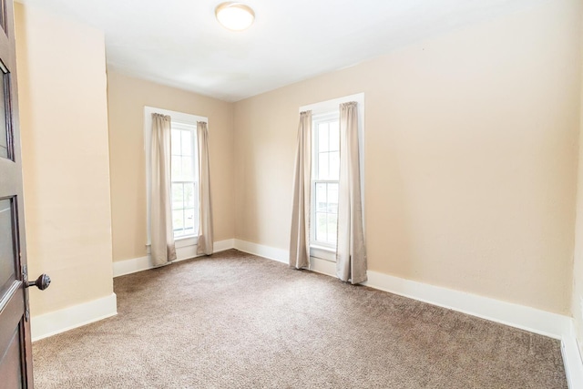 spare room with carpet flooring and baseboards
